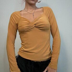 Mustard yellow long sleeve top with a twist in the middle